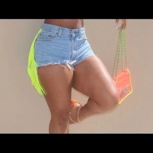 Customized neon green fringe shorts